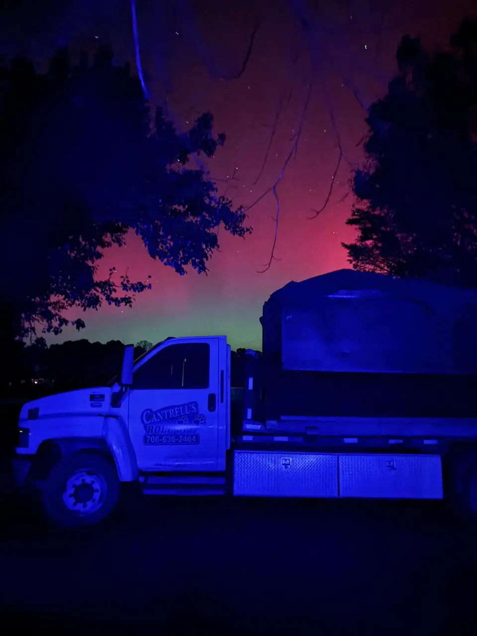 Cantrell's company truck parked at night under a purple sky